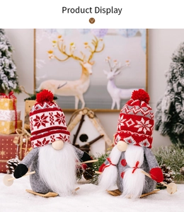 Detail of Christmas gnomes on wooden skis featuring red snowflake knitted hats and grey felt