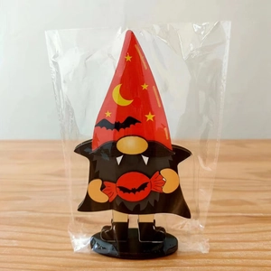 Close-up of a wooden Halloween vampire gnome ornament with moon and bat patterns