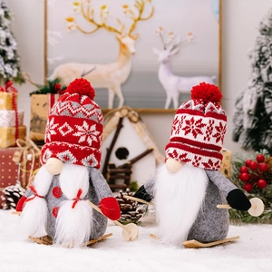 Detail of Christmas gnomes with knitted hats and wooden skis in a festive indoor scene