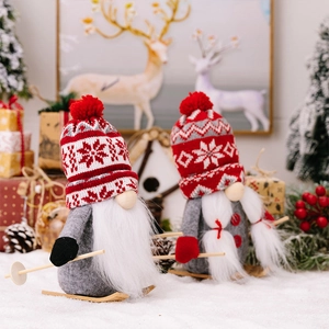 Detail of Christmas gnomes on wooden skis featuring knit hats and festive decorations