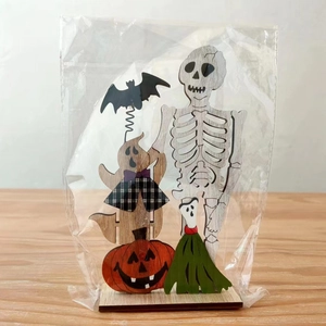 Detailed view of Halloween wooden table decor with skull and pumpkin in clear packaging