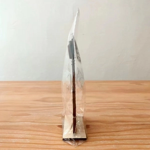 Side view showing the thickness of the Halloween wooden stand with its base and packaging
