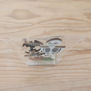 Close-up of wooden Halloween skeleton and pumpkin desk ornament in flat packaging