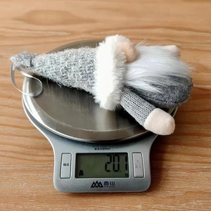 Close-up of a Christmas gnome ornament on a digital scale showing weight of 20.1g