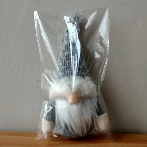 Detailed view of a Christmas gnome ornament with grey knitted hat and sparkling silver star