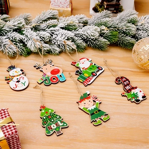 Macro detail of wooden Christmas tree ornaments with colorful snowman and Santa motifs