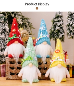 Close-up of four colorful Christmas gnomes with knitted hats and pearl snowflake details