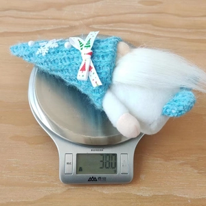 Detailed view of a blue knitted Christmas gnome plush doll weighing 38.0g on a digital scale