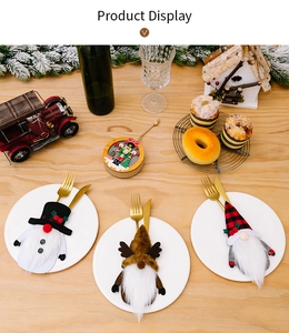 Close-up of festive gnome cutlery holders featuring snowman and reindeer doll designs