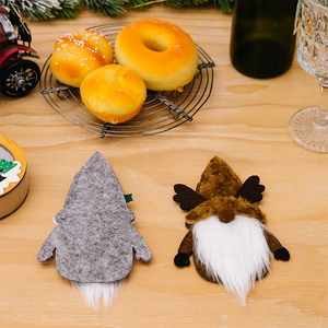 Detailed view of Scandinavian Christmas gnome cutlery holders on a rustic wooden table