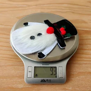 Close-up of snowman gnome cutlery holder weighing 9.3g on a scale for Christmas decor
