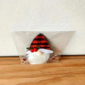 Detailed view of Christmas gnome cutlery holder with red black buffalo plaid pattern