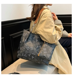 Detail view of the printed tote bag set featuring silver chain strap and small pouch