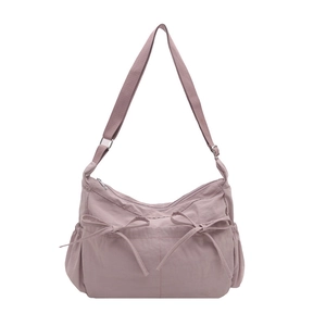 Pink pleated tote bag with bow drawstring accents and adjustable shoulder strap for women