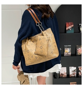 Detail view of khaki monogram tote bag with chain strap and matching small pouch