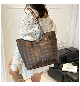Close-up of brown bear print tote bag and mini pouch set worn on the shoulder