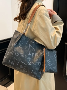 Retro black tote bag with letter pattern, brown leather straps and silver chain detail