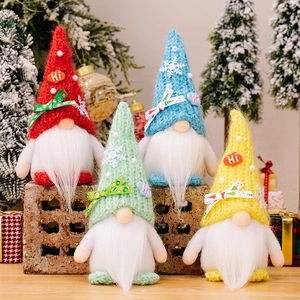Set of 4 Christmas gnomes with colorful knit hats and snowflake decor in a festive setting