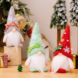 Three festive Christmas gnomes in red, green and grey with knit hats and snowflakes