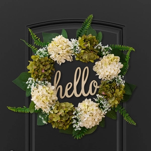 Detail of faux hydrangea wreath with green leaves and a beige Hello wooden sign