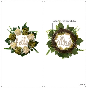 Detail view of artificial hydrangea wreath with wood Hello sign and rattan base