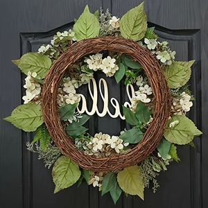 Artificial hydrangea leaf wreath with wooden Hello sign on grey front door decoration