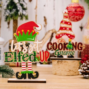 Detailed view of festive Christmas wooden signs with gnome motifs and steady black bases