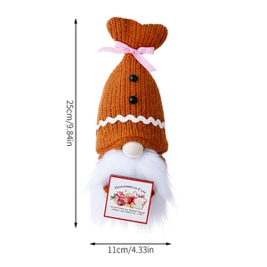 Close-up of Gingerbread Cafe gnome doll with knitted orange hat and 25cm size markings