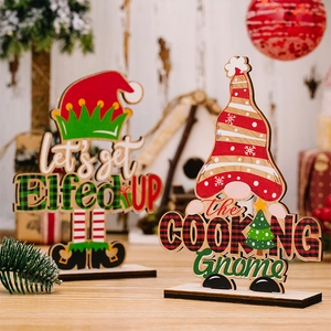 Detailed view of Christmas gnome and elf wooden signs on a festive tabletop display