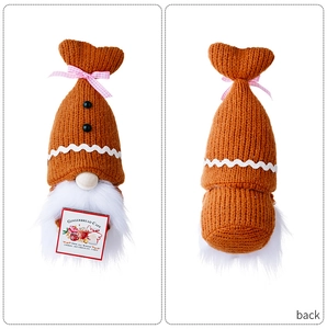 Front and back detail of a gingerbread knit Christmas gnome with white beard and cafe sign