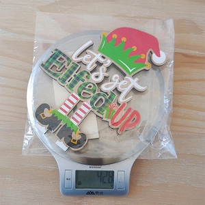 Measurement of wooden Christmas gnome sign Let's get Elfed Up showing weight on scale