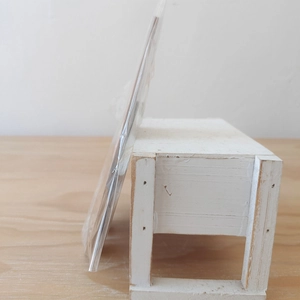 Close-up of slim wooden Christmas gnome sign in transparent plastic protective packaging