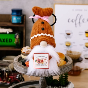 Detail of gingerbread gnome holding a Gingerbread Cafe sign for festive home decor