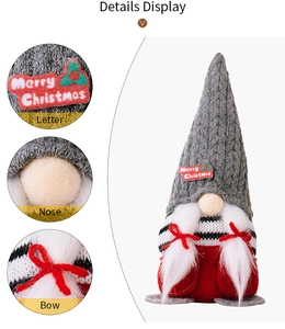 Detail view of Merry Christmas embroidery and red bow on a festive plush gnome doll