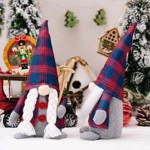Close-up of handmade Christmas gnomes set with red plaid hats and skiing accessories