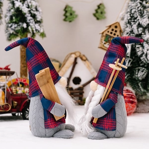 Macro detail of plush Christmas gnomes with plaid hats and ski gear in a winter scene