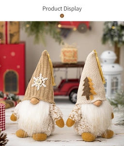 Detailed view of handmade Christmas gnomes with knit hats and faux fur beards on a festive desk