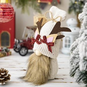 Detail of Christmas gnome with knit shell, reindeer antlers, and cozy holiday decor