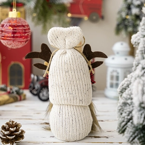 Macro detail of knitted Christmas gnome with brown antlers and soft grey faux fur beard