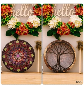 Detail of Shamanic drum featuring colorful mandala pattern and Tree of Life weaving with mallet