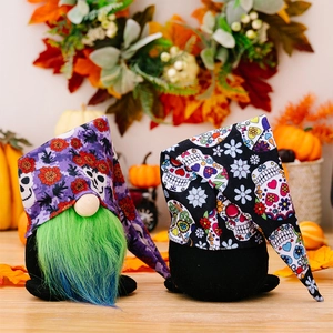 Detail of plush Halloween gnomes with skull pattern hats and green beards for decor