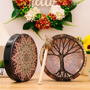 Detail of bohemian shaman frame drums featuring tree of life and mandala patterns