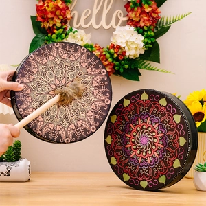 Detailed view of bohemian shaman drums with mandala patterns and wooden mallet set