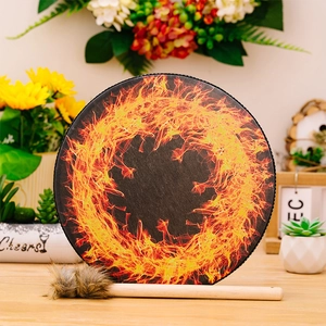 Detail of bohemian shaman frame drum with orange fire pattern and plush wood mallet