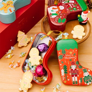 Detail of Christmas stocking tin boxes featuring Nutcracker and Snowman patterns