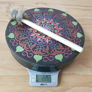 Detail shot of a bohemian shaman drum with mandala pattern and mallet weighing 226.5g