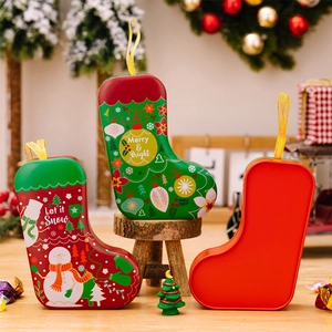 Detailed view of snowman Christmas stocking tin boxes with silk ribbon handles on wood