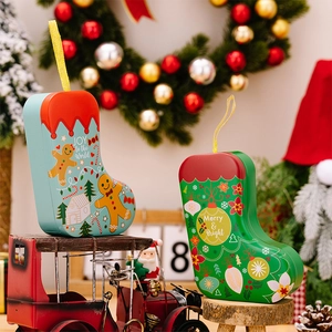 Detail of Christmas stocking shaped tin gift boxes with festive gingerbread man patterns