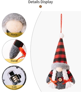 Detail view of red plaid gnome with glowing nose and battery compartment on white base