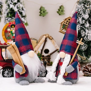 Pair of Christmas gnome figurines with red-blue plaid hats on snow-themed background